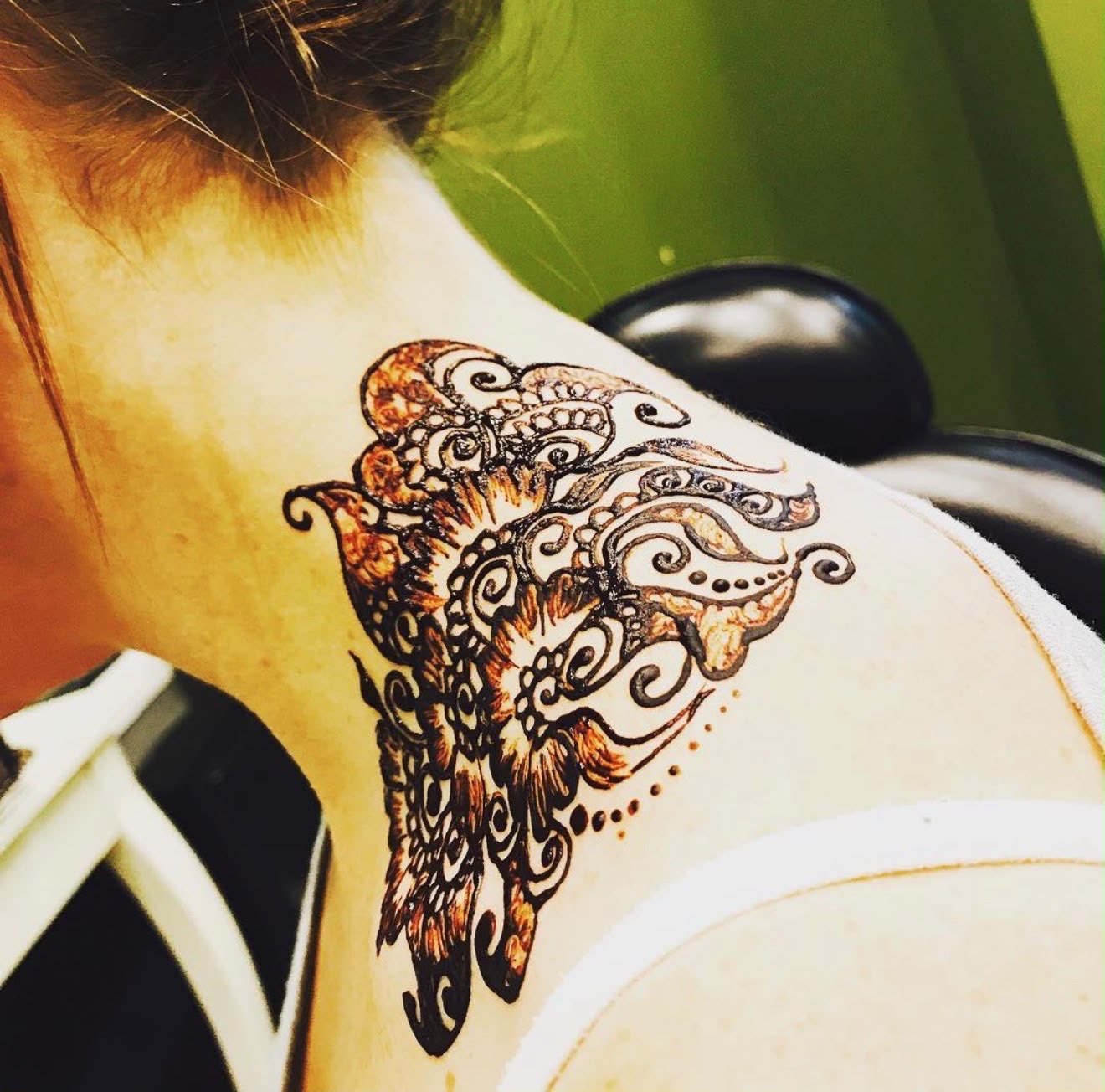 Henna mandala design on neck and shoulder