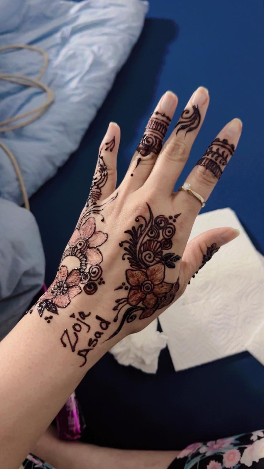 Floral henna with pink glitter accents